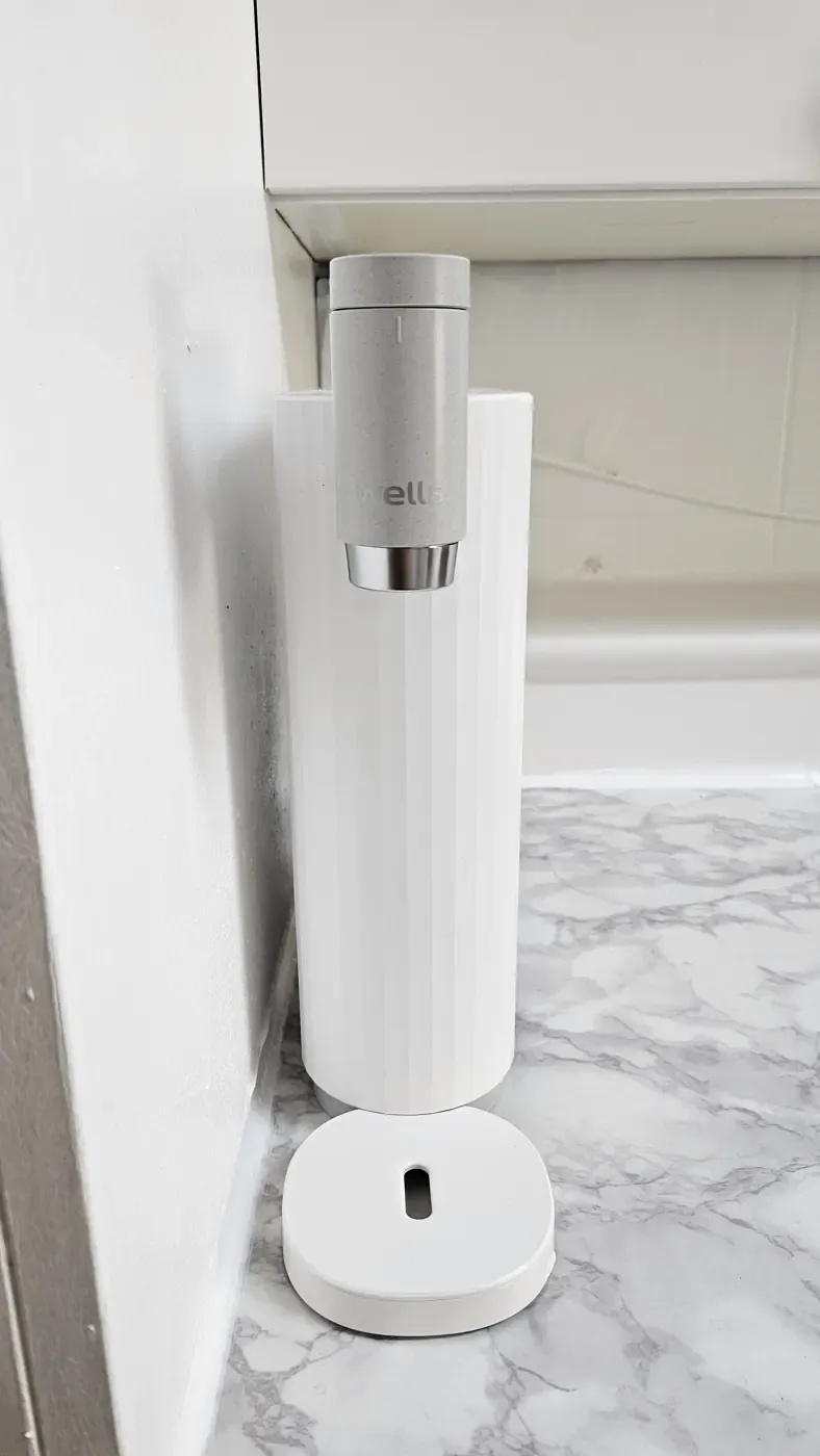 A white water purifier standing on a counter in a Korean convenience store