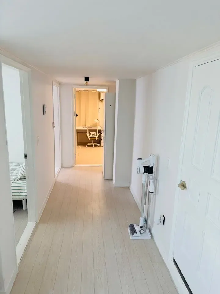 A hallway leading to the rooms