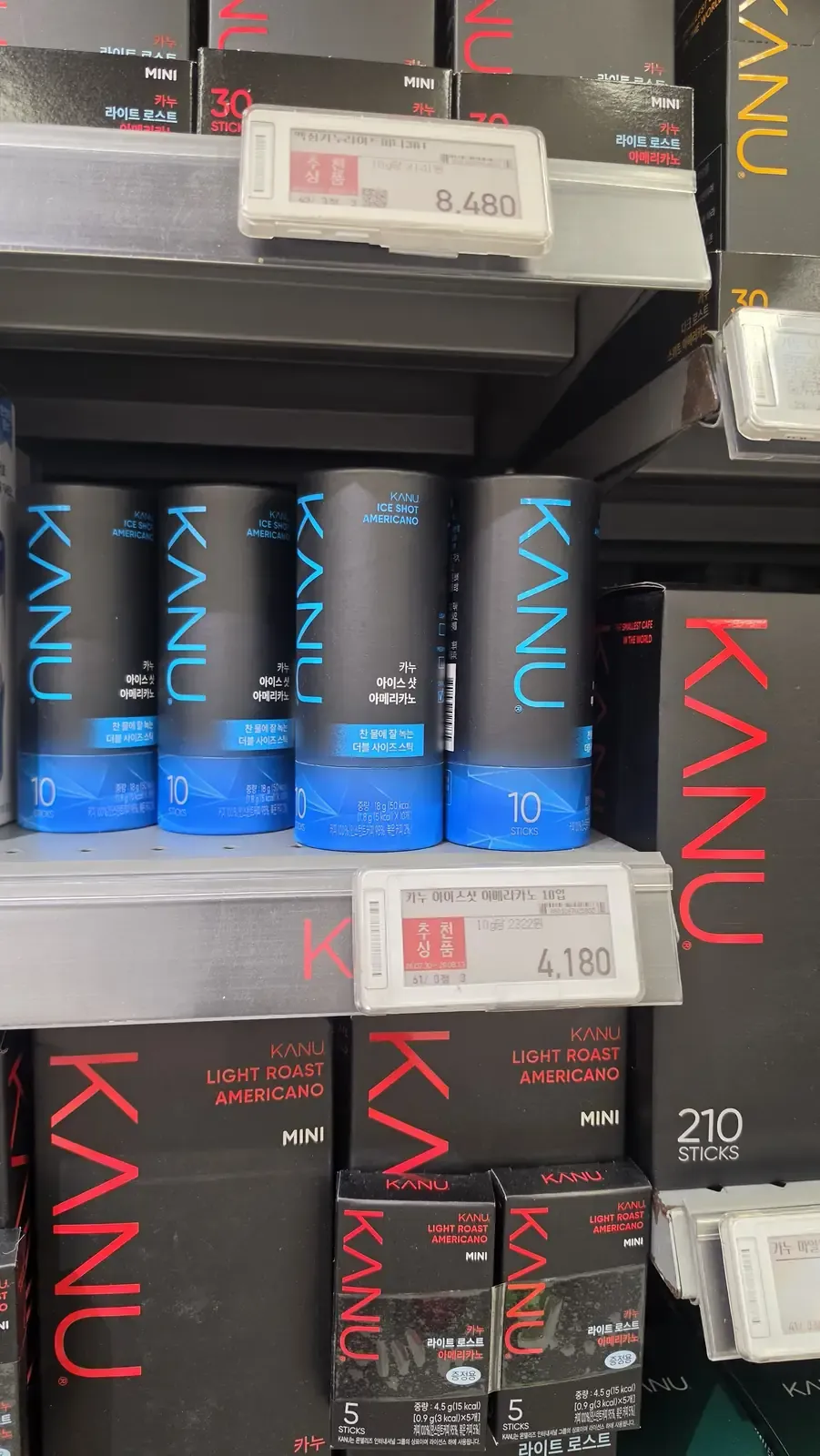 Blue tubes of KANU Ice Shot Americano on a supermarket shelf with a price label reading 4,180 won