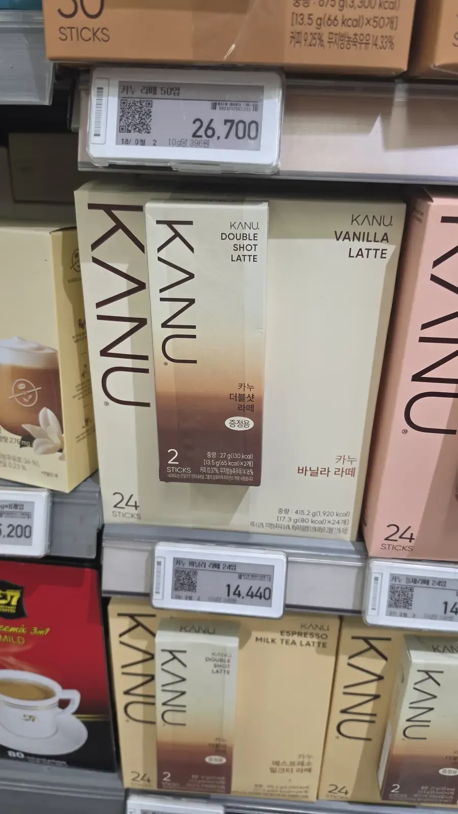Cream and pink boxes of KANU vanilla latte and double shot latte with price labels