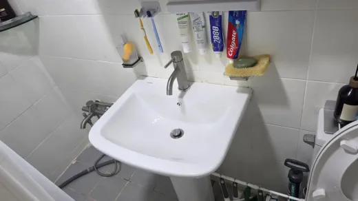 A new pedestal sink installed in a Korean bathroom