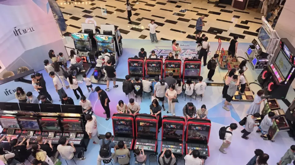 Overhead view of a retro arcade event floor inside IFC Mall Yeouido, with rows of arcade cabinets and crowds playing