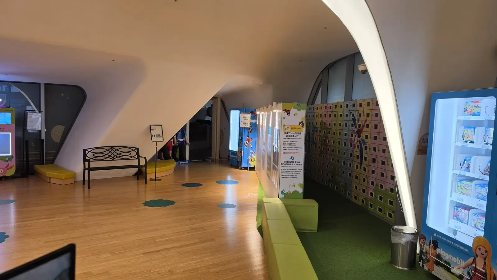 A sign asking visitors to use an empty shoe cabinet and to remove children's socks for safe play at a Korean kids cafe