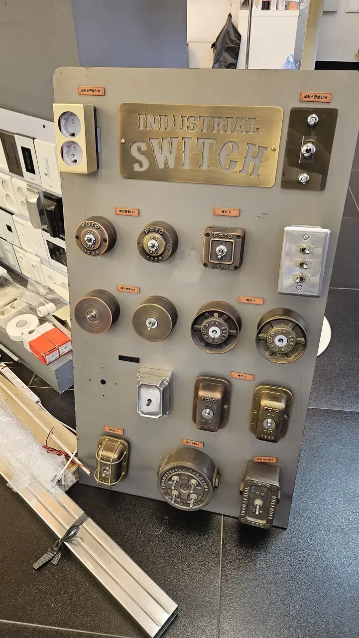 A display board inside a Korean hardware shop covered in switches, sockets and industrial-style fittings