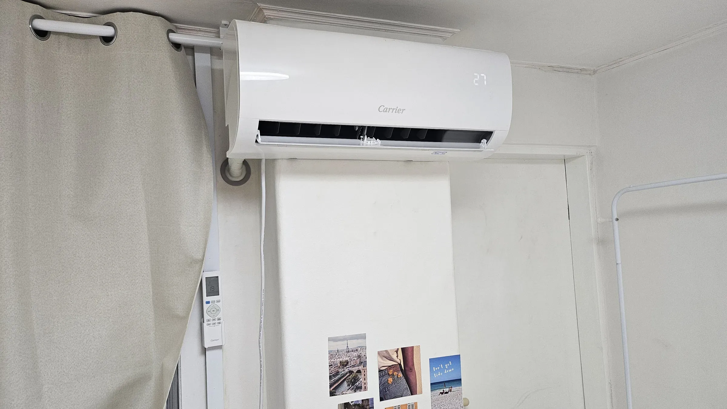 An air conditioner running with the vent fully open, showing the louvres and the interior behind them